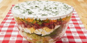 Une salade étagée colorée parfaite pour les repas-partage et les pique-niques. C'est une salade printanière simple et belle, et un aliment de base des repas-partage et des déjeuners dans ma région du pays. Vous pouvez varier les ingrédients selon vos goûts et ce que vous avez dans votre frigo, et vous pouvez l'agrémenter un peu d'herbes fraîches, de gorgonzola, tout ce qui fait voler votre jupe ! Les ingrédients standard de la plupart des salades en couches sont de la laitue ou des épinards (ou les deux !), Des œufs durs, du bacon émietté, du fromage râpé, des oignons verts et des pois verts, qui sont disposés en couches dans un joli bol en verre afin que les couches puissent être vues dans tous les sens. leur beauté colorée.